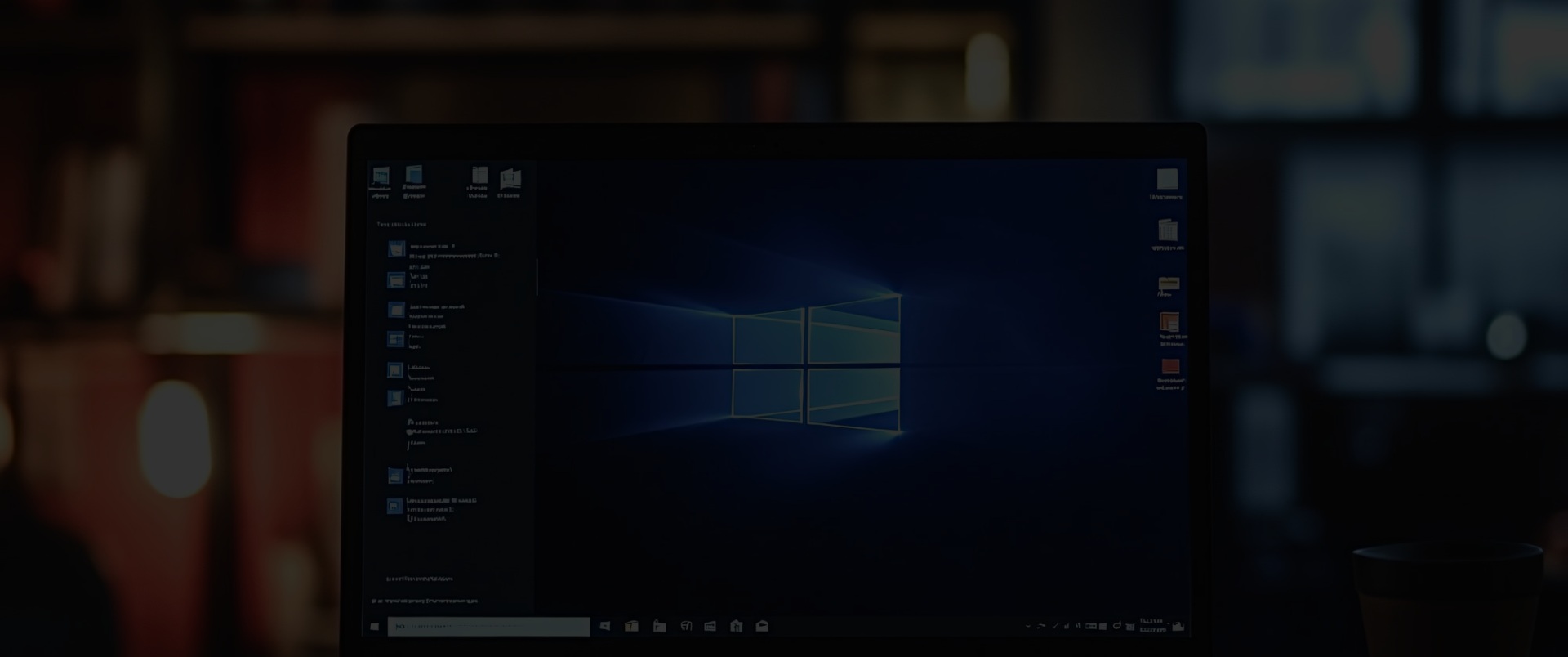 Modern laptop displaying operating system on wooden desk in office